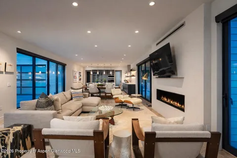 a living room with fireplace furniture and a flat screen tv
