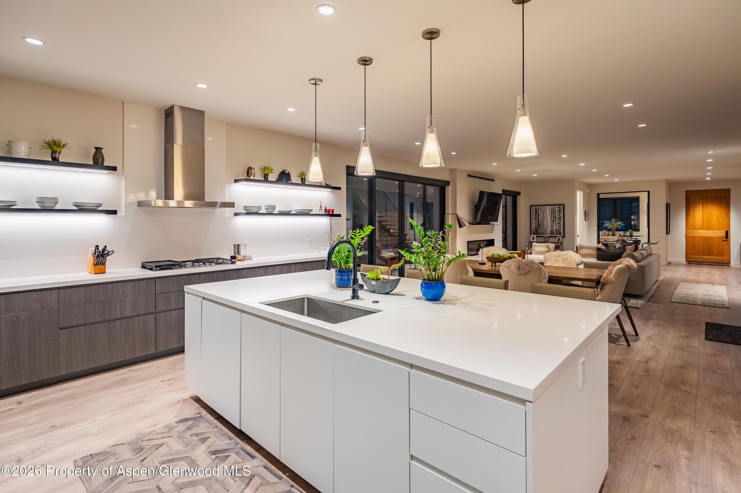 219 Juniper Court Basalt, CO 81621 - Photo 8 of 25 a kitchen with kitchen island granite countertop a sink and white cabinets