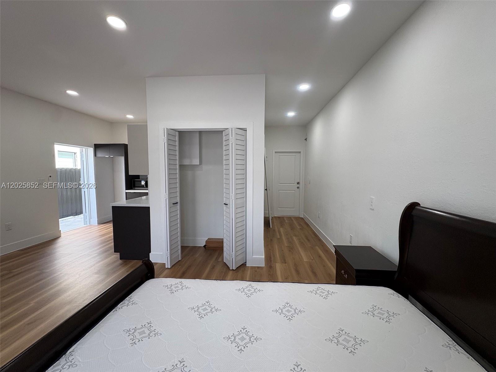 12948 Southwest 265th Terrace, Unit STUDIO Homestead, FL 33032 - Photo 13 of 16 a bed room with a bed