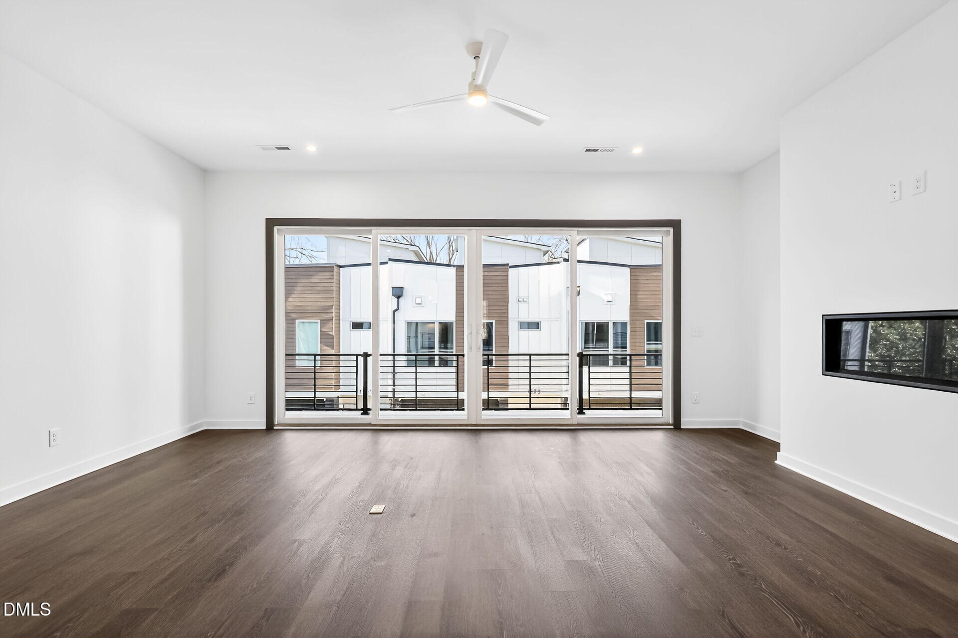 1521 1/2 Sunrise Avenue Raleigh, NC 27608 - Photo 12 of 37 a view of an empty room with wooden floor and a window
