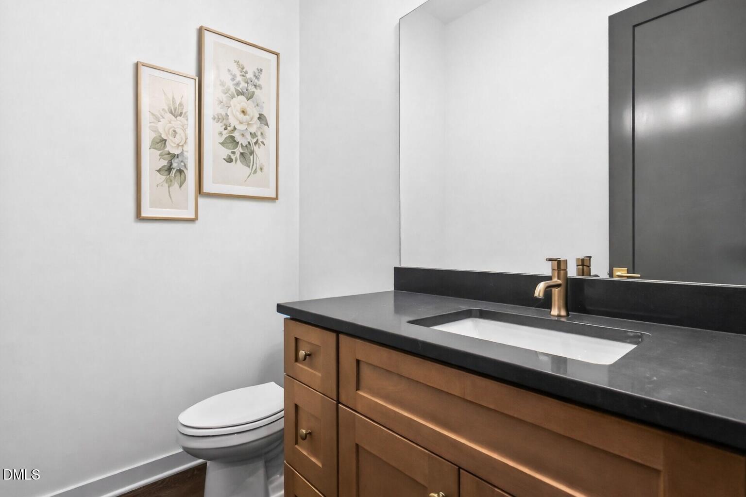 1521 1/2 Sunrise Avenue Raleigh, NC 27608 - Photo 21 of 37 a bathroom with a granite countertop sink and a mirror