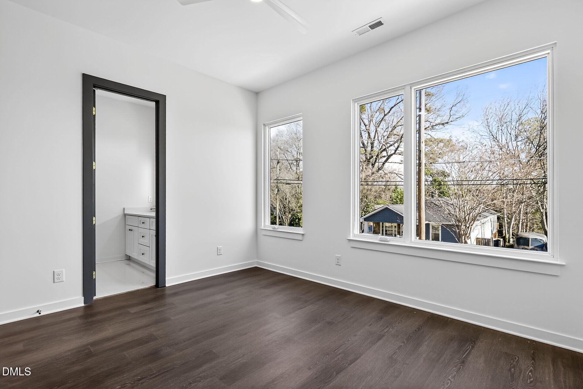1521 1/2 Sunrise Avenue Raleigh, NC 27608 - Photo 23 of 37 an empty room with wooden floor and windows