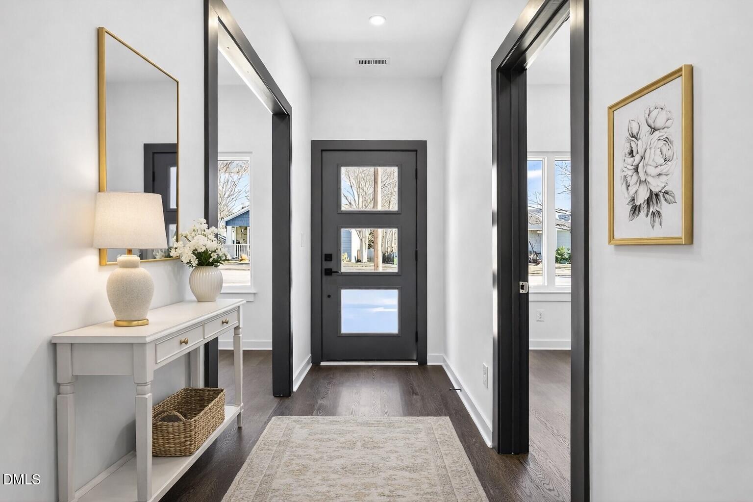 1521 1/2 Sunrise Avenue Raleigh, NC 27608 - Photo 3 of 37 a view of hallway with chandelier and wooden floor