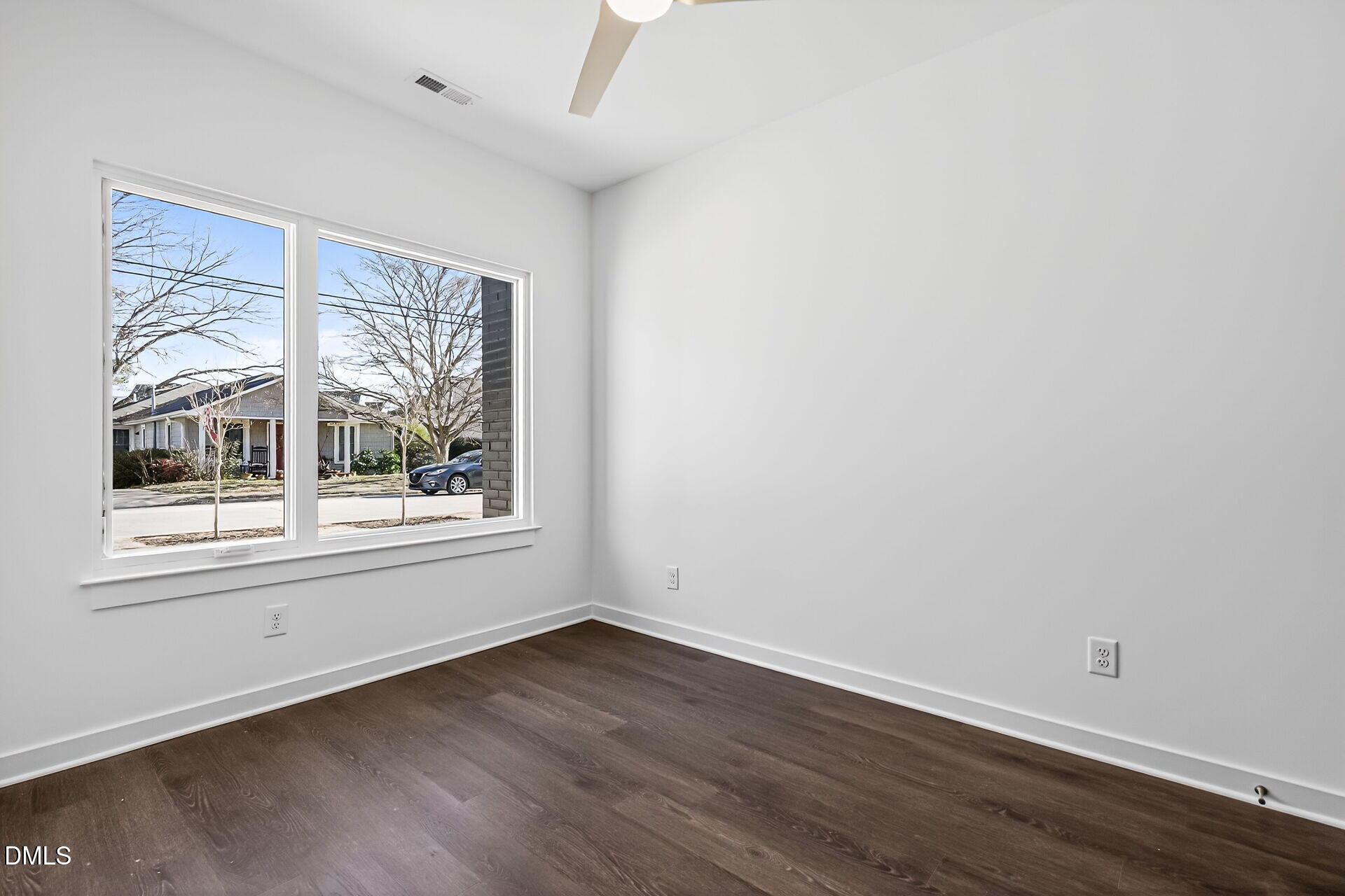 1521 1/2 Sunrise Avenue Raleigh, NC 27608 - Photo 9 of 37 an empty room with wooden floor and windows