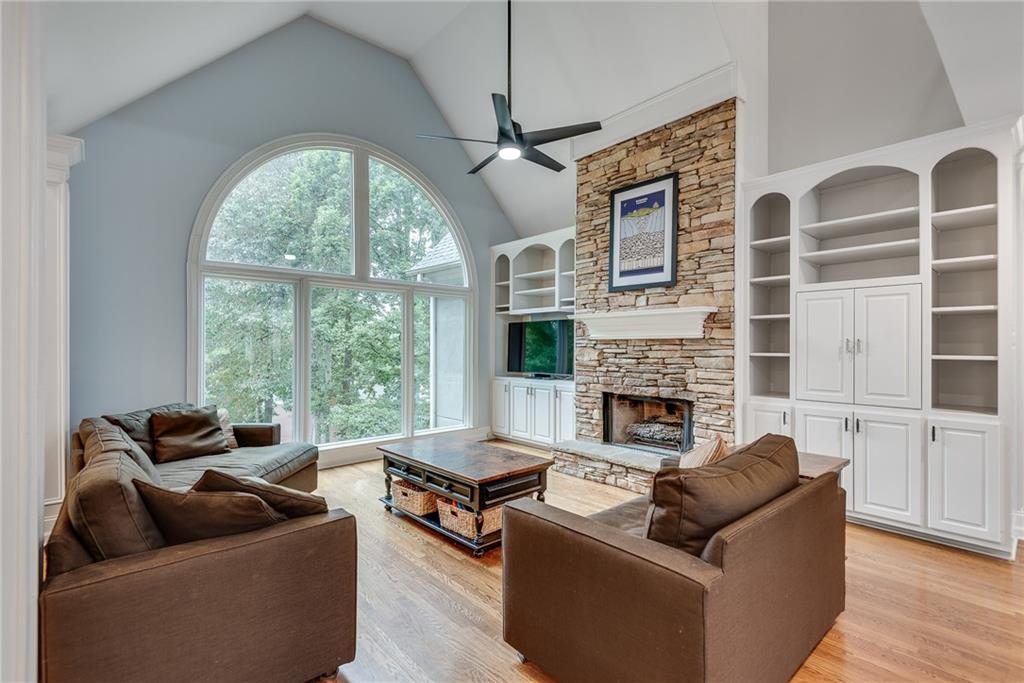 3969 Walkers Ridge Court Dacula, GA 30019 - Photo 14 of 60 a living room with furniture a large window and a fireplace