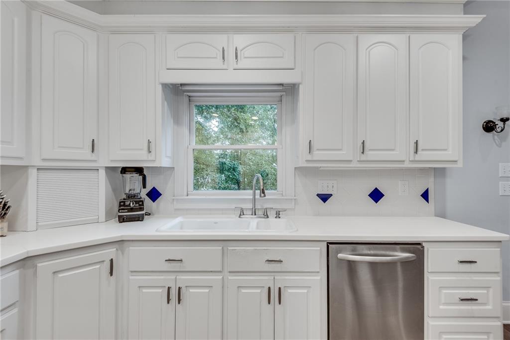 3969 Walkers Ridge Court Dacula, GA 30019 - Photo 25 of 60 a kitchen with white cabinets and a sink