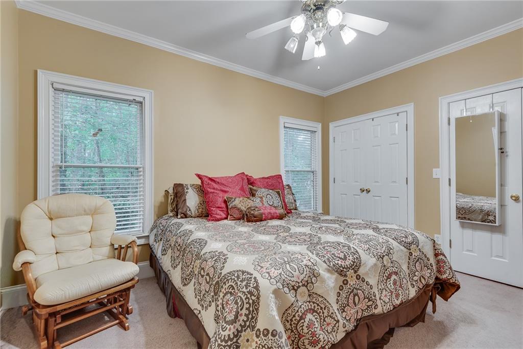 3969 Walkers Ridge Court Dacula, GA 30019 - Photo 30 of 60 a bedroom with a bed and a couch