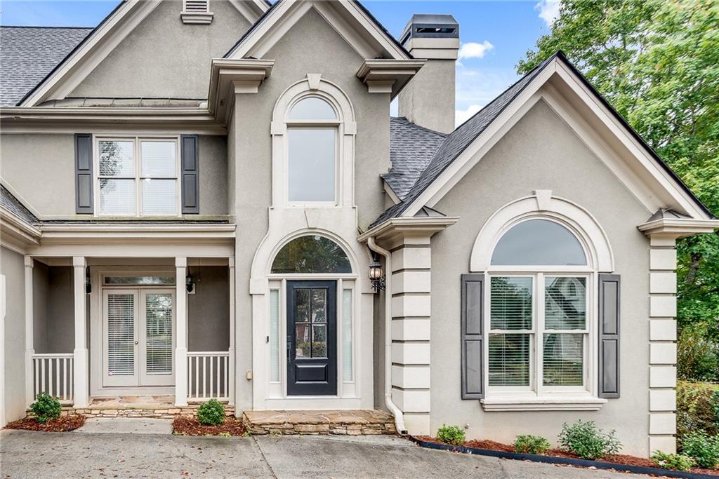 3969 Walkers Ridge Court Dacula, GA 30019 - Photo 3 of 60 a view of a brick house with large windows