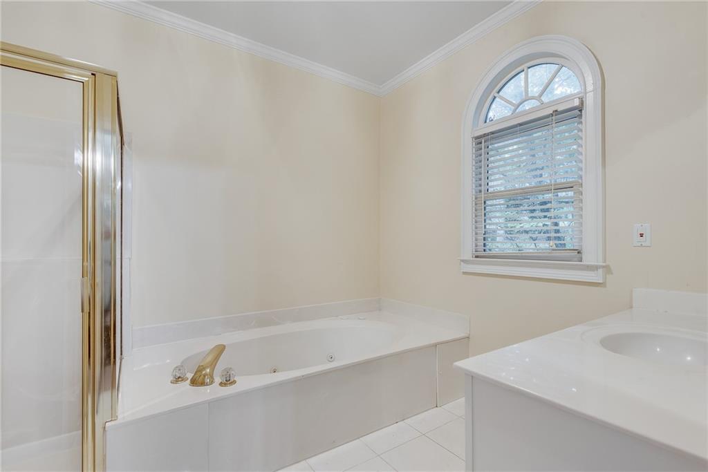 3969 Walkers Ridge Court Dacula, GA 30019 - Photo 32 of 60 a bathroom with a bathtub and a window