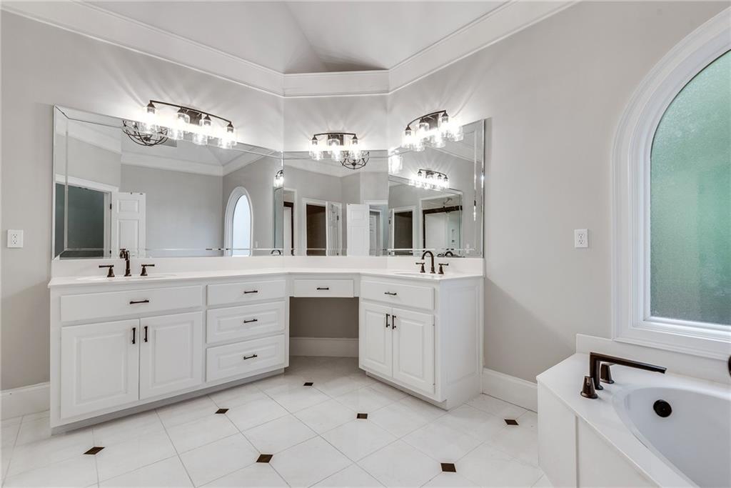 3969 Walkers Ridge Court Dacula, GA 30019 - Photo 39 of 60 a spacious bathroom with a double vanity sink mirror and bathtub