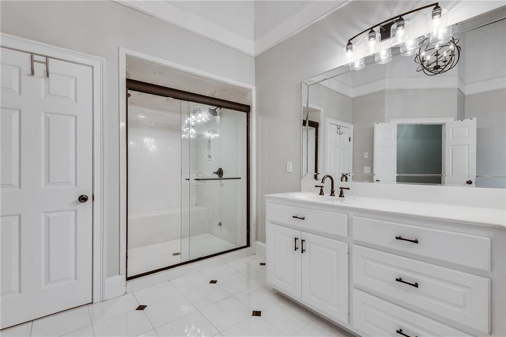 3969 Walkers Ridge Court Dacula, GA 30019 - Photo 40 of 60 a bathroom with a double vanity sink mirror and shower