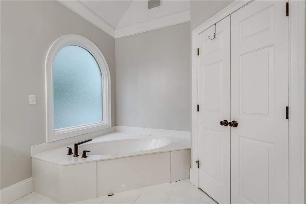 3969 Walkers Ridge Court Dacula, GA 30019 - Photo 42 of 60 a bathroom with a sink a mirror and shower