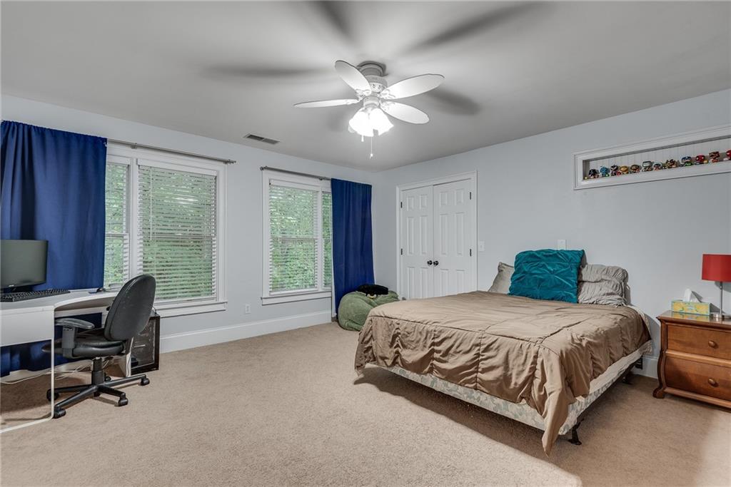 3969 Walkers Ridge Court Dacula, GA 30019 - Photo 49 of 60 a bedroom with a bed and a desk