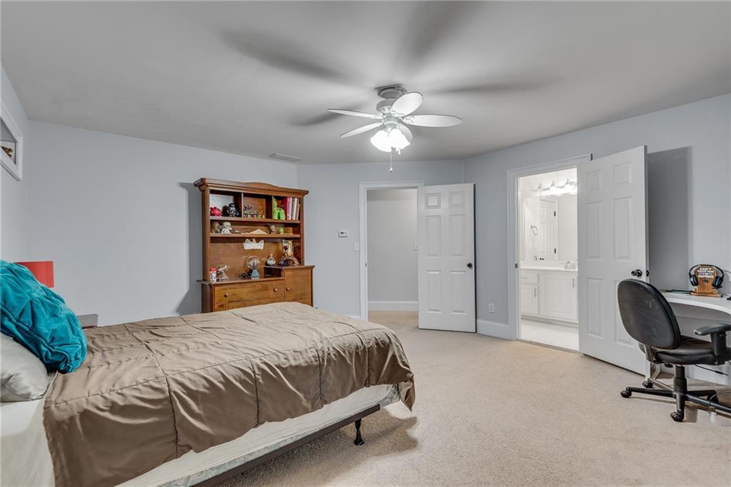 3969 Walkers Ridge Court Dacula, GA 30019 - Photo 50 of 60 a bedroom with a bed and a chandelier
