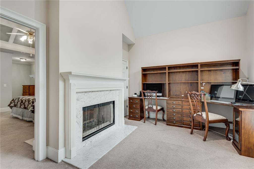 3969 Walkers Ridge Court Dacula, GA 30019 - Photo 8 of 60 a living room with furniture a flat screen tv and a fireplace