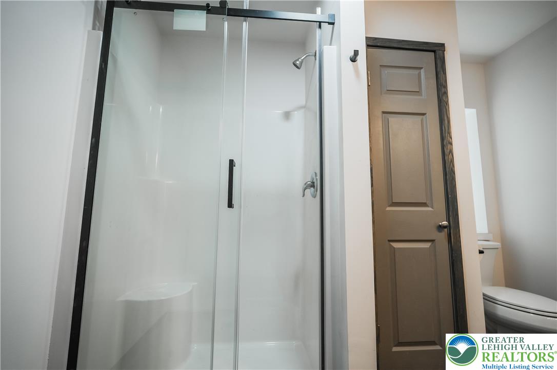 335 Walnut Drive, Unit 1 Northampton, PA 18067 - Photo 11 of 29 a bathroom with a glass shower door