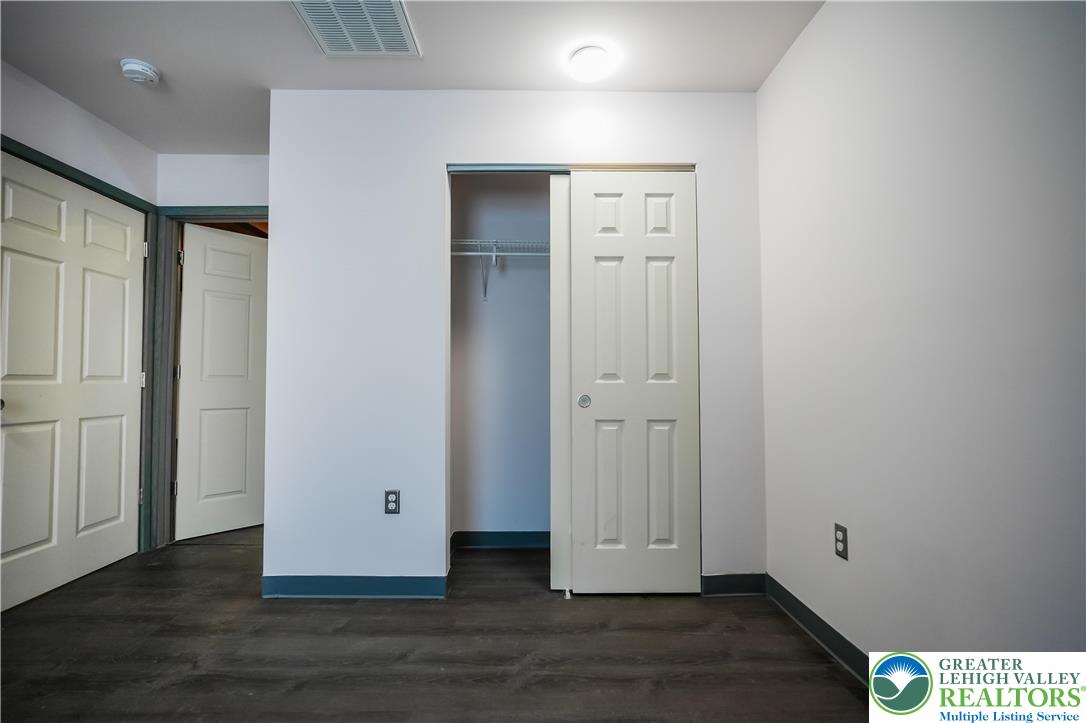 335 Walnut Drive, Unit 1 Northampton, PA 18067 - Photo 14 of 29 an empty room with wooden floor & closet area