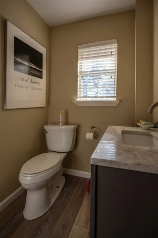 a bathroom with a toilet a sink and mirror