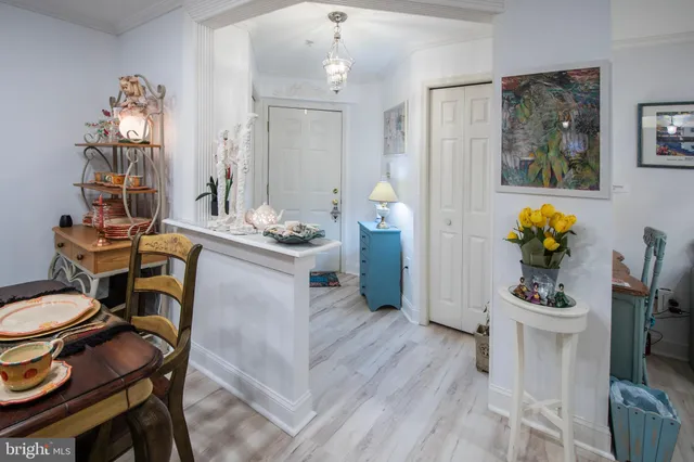 a dining room filled chandelier and wooden floor