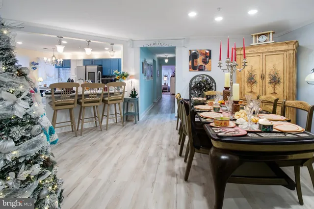 a dining room with furniture and wooden floor