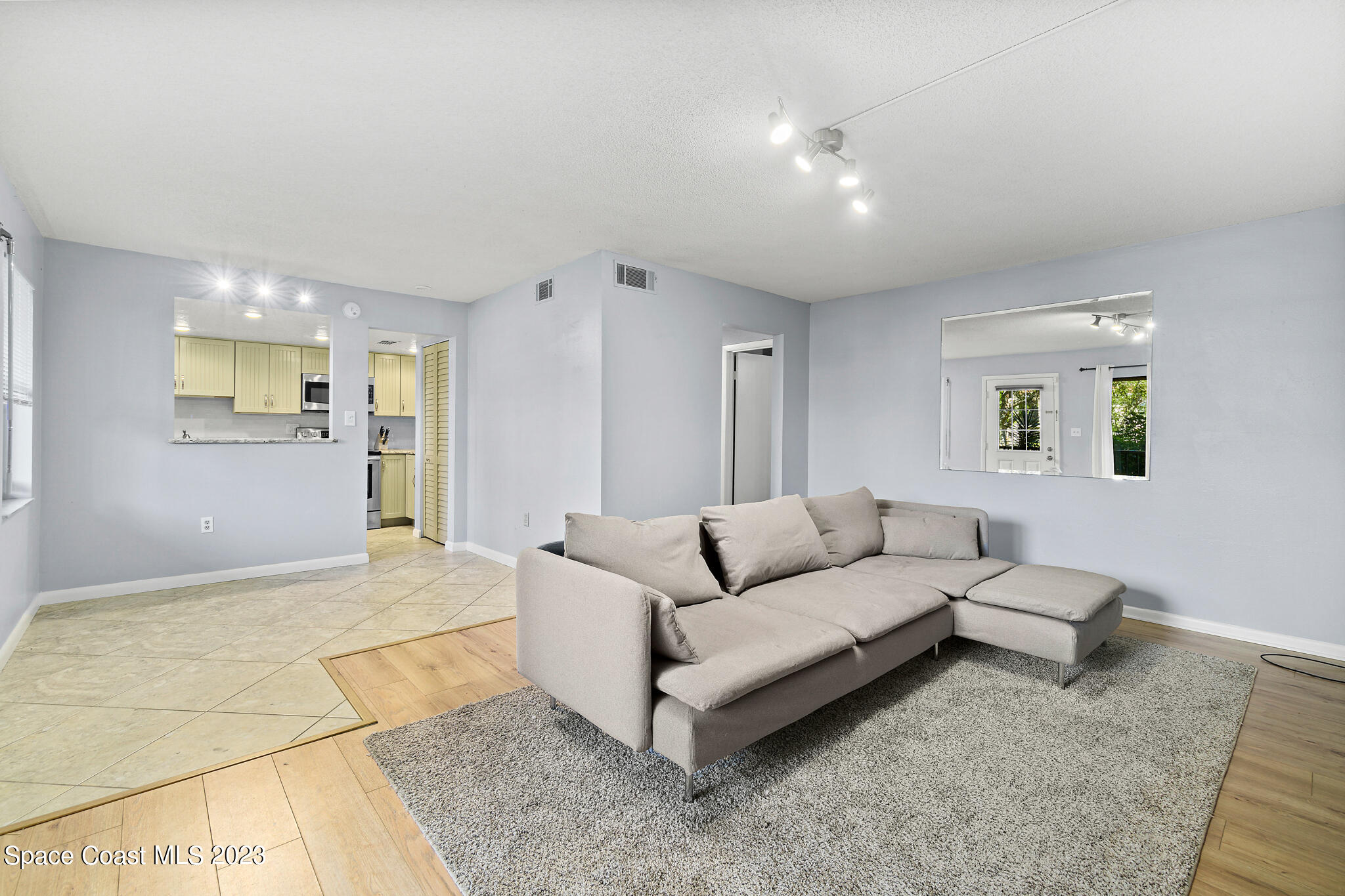500 Catalina Road, Unit 103 Cocoa Beach, FL 32931 - Photo 12 of 28 a living room with furniture and a table