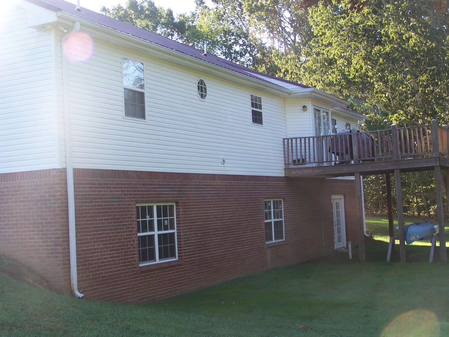 1990 Nancy Green Ridge Road Prospect, TN 38477 - Photo 22 of 28 Back of the home showing deck and outside entrance to full size basement
