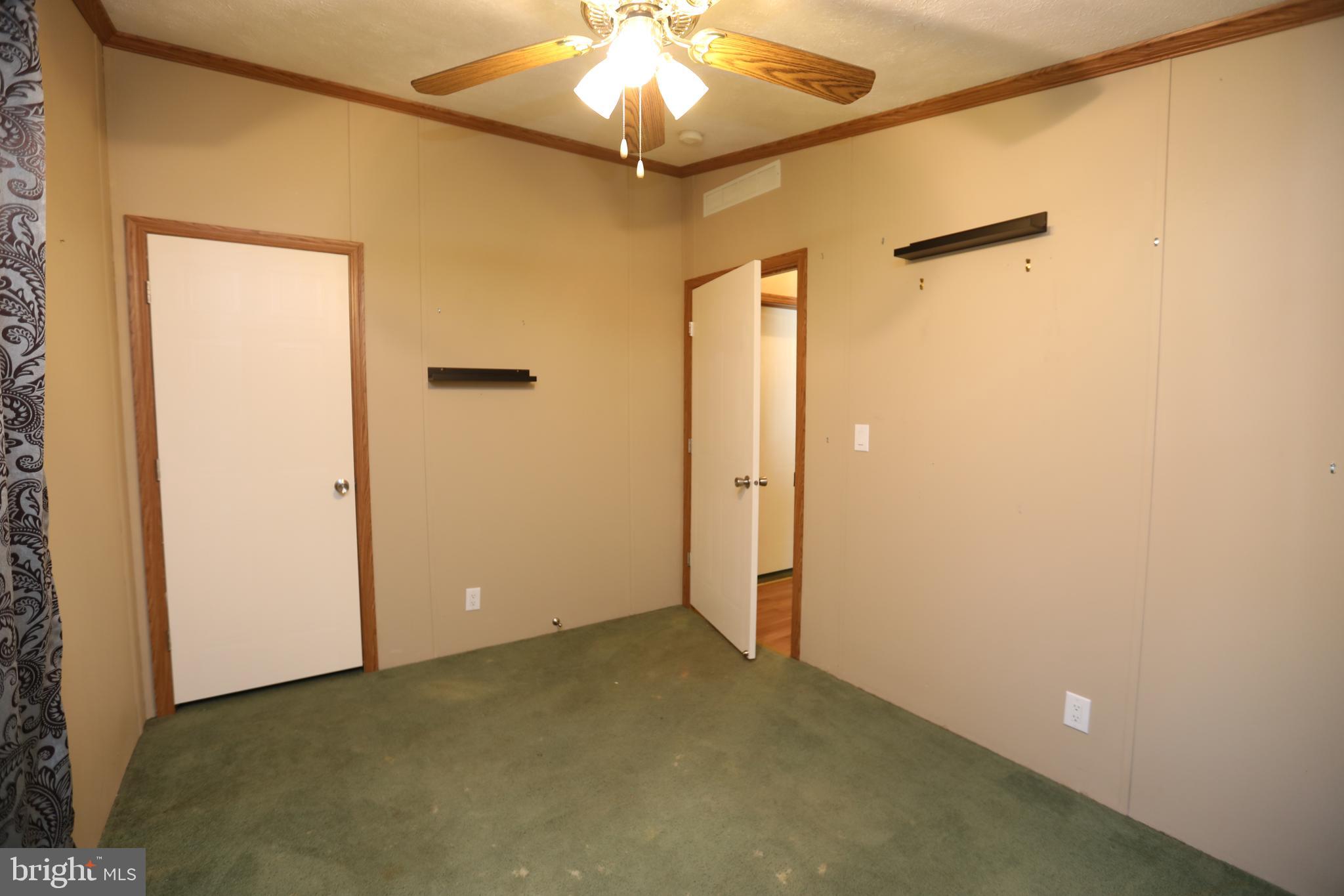 2439 Fairmount Road, Unit 11 Hampstead, MD 21074 - Photo 26 of 29 an empty room with a ceiling fan and a window