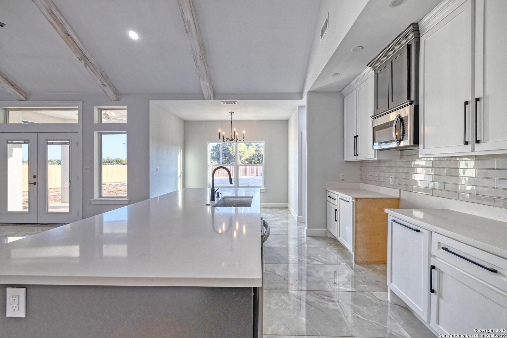 14 Hope Place Uvalde, TX 78801 - Photo 11 of 38 a large kitchen with kitchen island a large counter top space a sink stainless steel appliances and cabinets