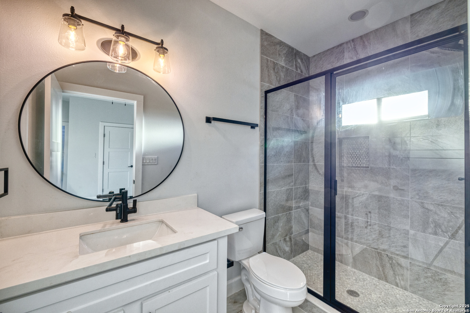 14 Hope Place Uvalde, TX 78801 - Photo 26 of 38 a bathroom with a sink a mirror and a shower