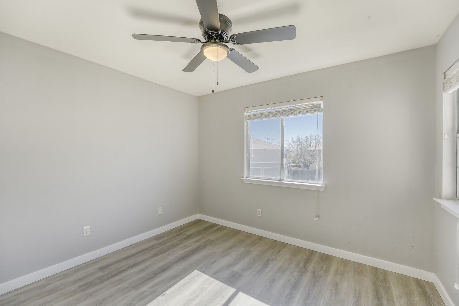904 Sebastian Bend, Unit B Pflugerville, TX 78660 - Photo 11 of 30 an empty room with a window and a ceiling fan