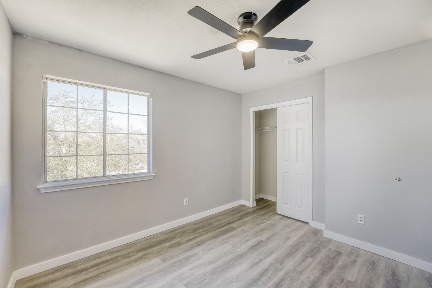 904 Sebastian Bend, Unit B Pflugerville, TX 78660 - Photo 15 of 30 an empty room with wooden floor and windows