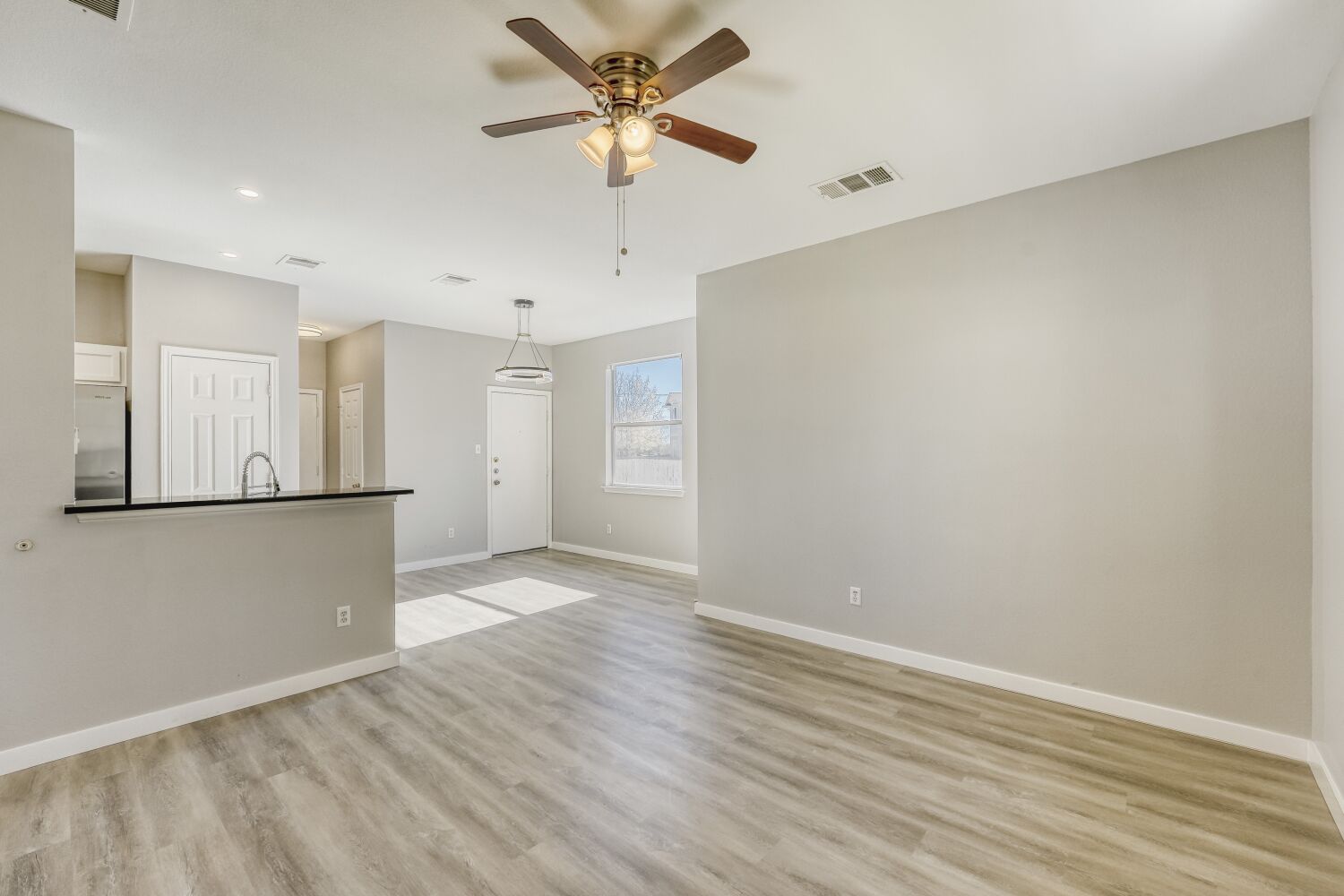 904 Sebastian Bend, Unit B Pflugerville, TX 78660 - Photo 4 of 30 wooden floor in an empty room with a window