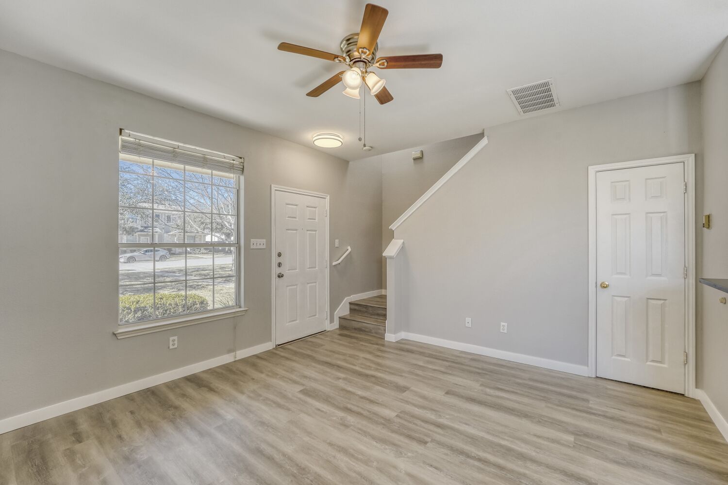 904 Sebastian Bend, Unit B Pflugerville, TX 78660 - Photo 6 of 30 wooden floor in an empty room with a window