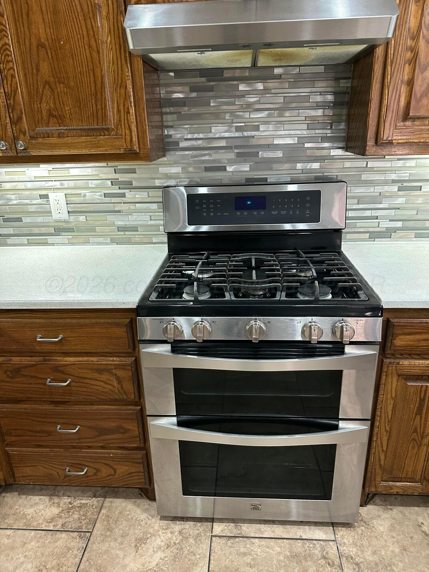 2 Cambridge Place Borger, TX 79007 - Photo 12 of 22 a stove top oven sitting inside of a kitchen