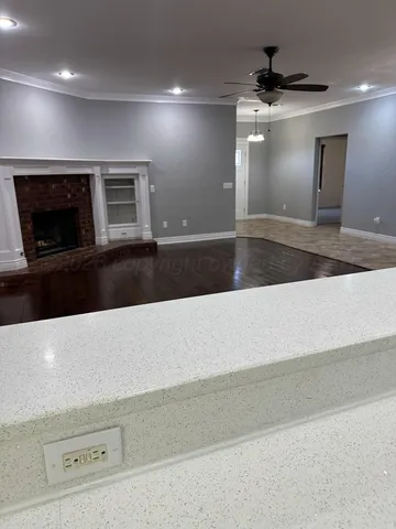 a kitchen with kitchen island granite countertop a sink and chandelier