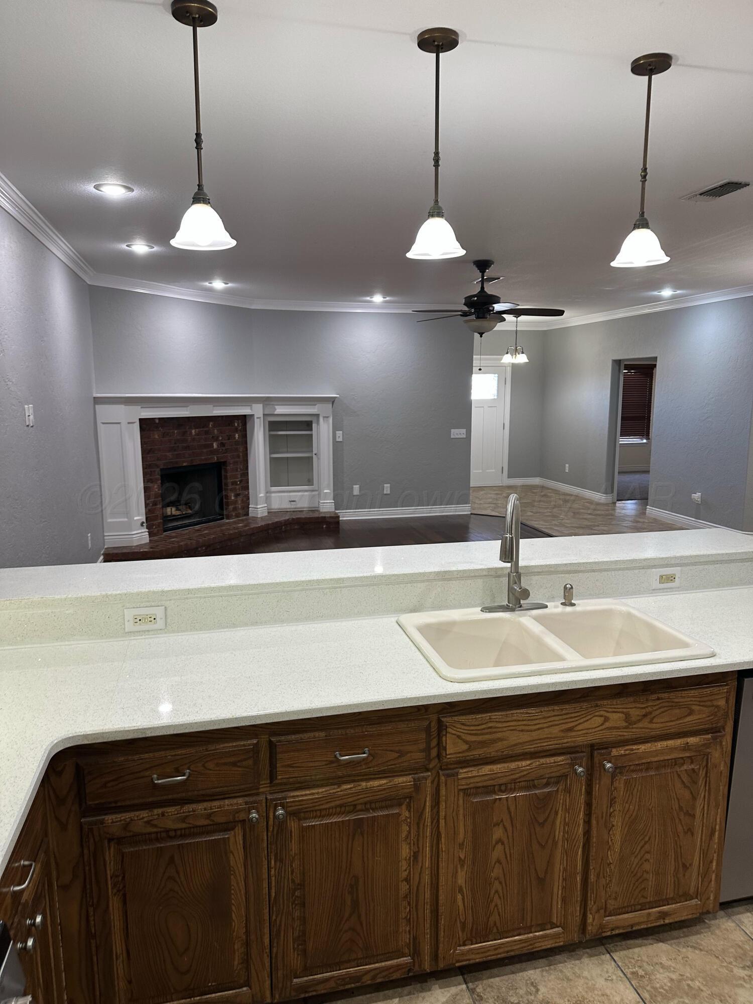 2 Cambridge Place Borger, TX 79007 - Photo 15 of 22 a kitchen with kitchen island granite countertop a sink and chandelier