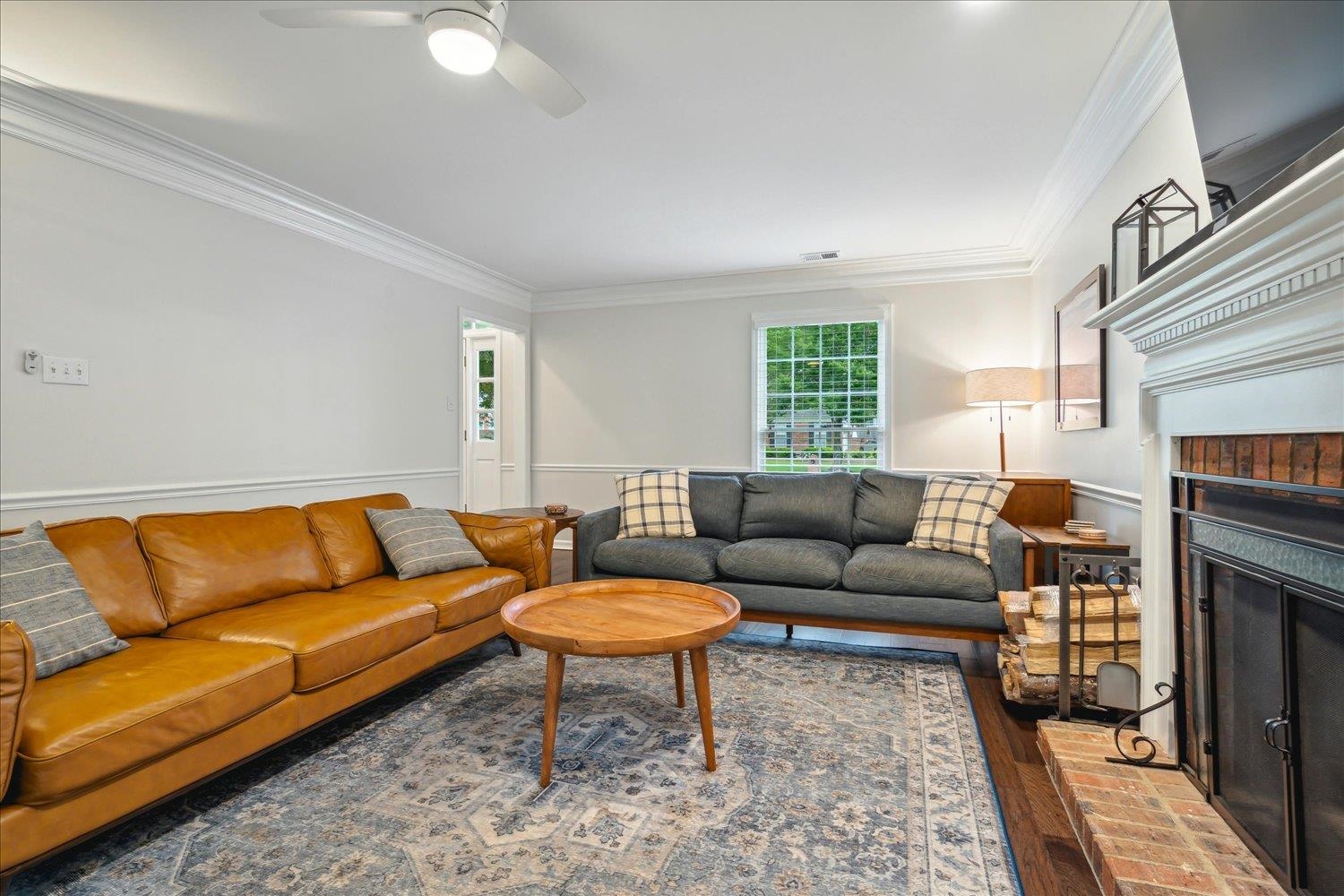 1001 Yorktown Road Collierville, TN 38017 - Photo 10 of 40 Living room featuring a fireplace, dark wood-type flooring, ceiling fan, and ornamental molding