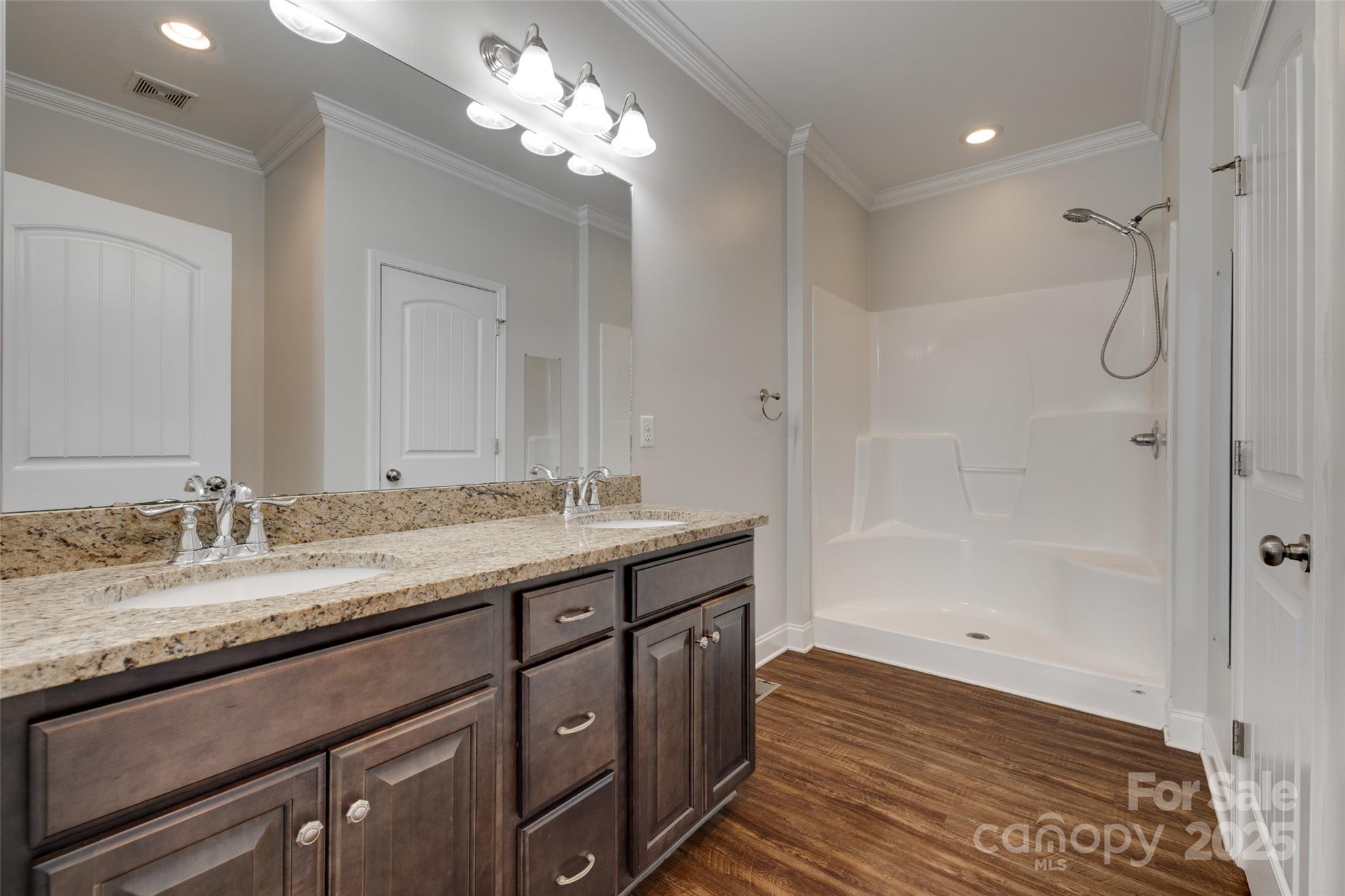 3243 Farmcrest Court Fort Mill, SC 29708 - Photo 13 of 45 a bathroom with a granite countertop sink two mirror and a shower
