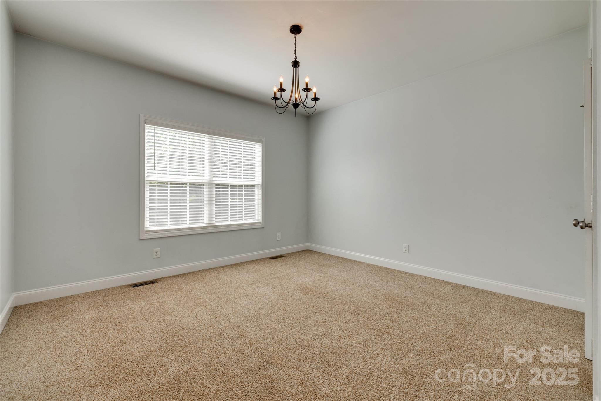 3243 Farmcrest Court Fort Mill, SC 29708 - Photo 16 of 45 an empty room with a chandelier fan and windows