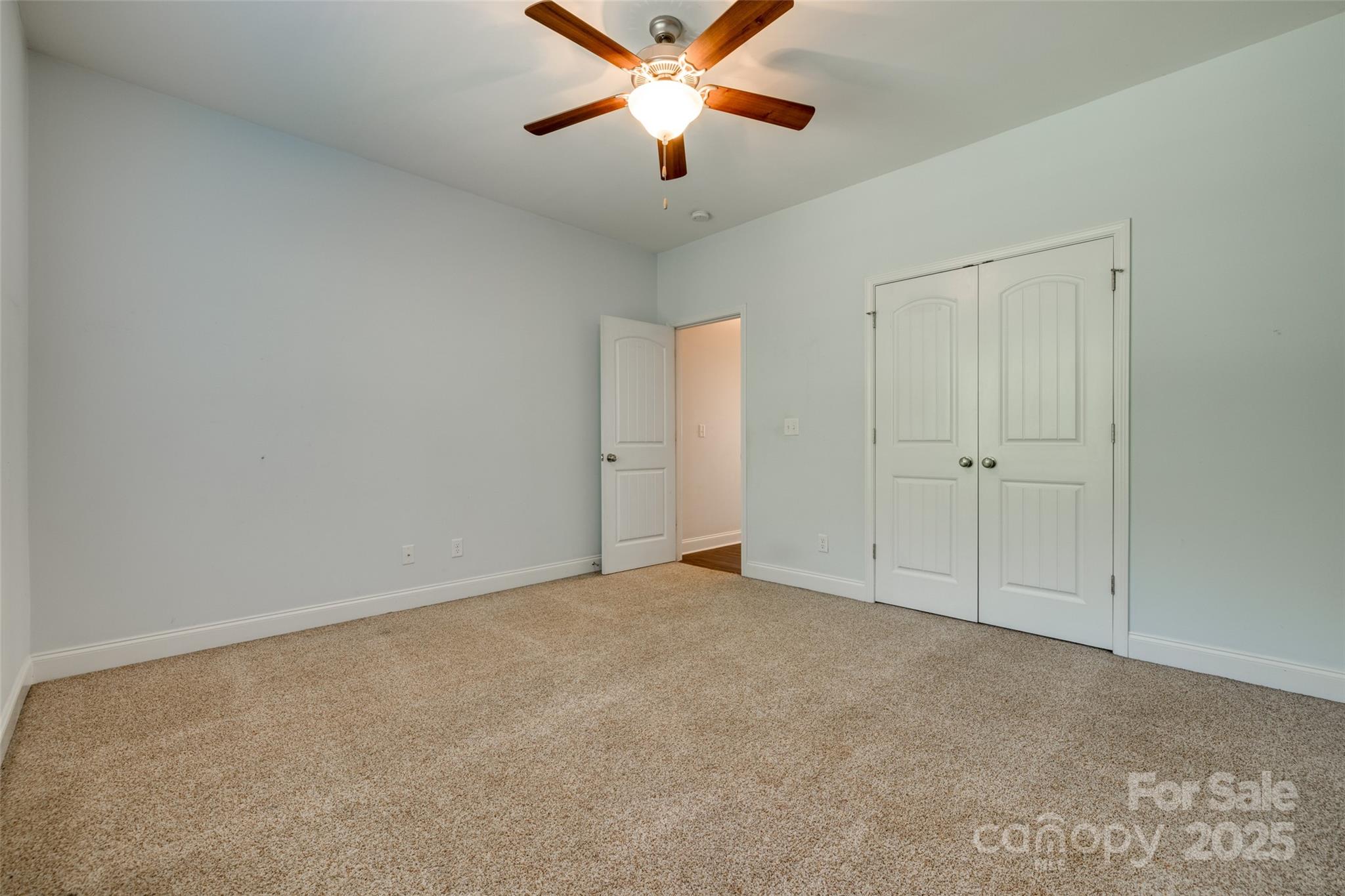 3243 Farmcrest Court Fort Mill, SC 29708 - Photo 20 of 45 an empty room with closet and a chandelier fan
