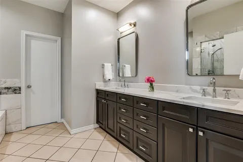 a bathroom with a double vanity sink mirror and double