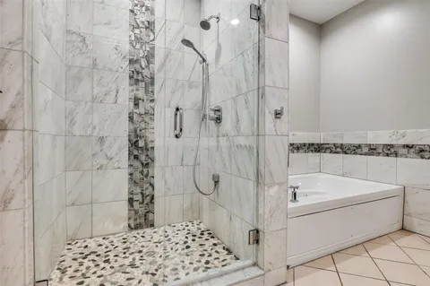 a bathroom with a bathtub and shower