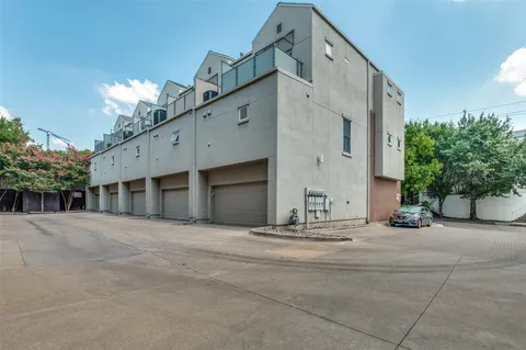 a view of a house with potted plants and a garage