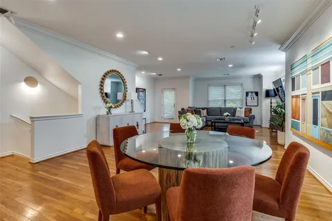 a kitchen with stainless steel appliances granite countertop a dining table chairs and granite counter tops