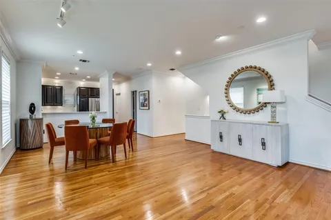 a view of a living room and kitchen hardwood floor