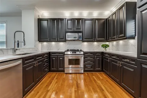 a kitchen with granite countertop a stove and a sink