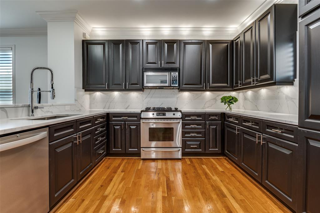 4223 Buena Vista Street, Unit 1 Dallas, TX 75205 - Photo 7 of 22 a kitchen with granite countertop a stove and a sink