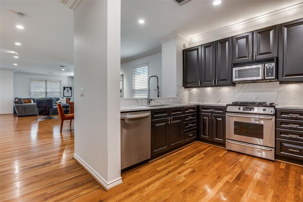 4223 Buena Vista Street, Unit 1 Dallas, TX 75205 - Photo 8 of 22 a kitchen with stainless steel appliances kitchen island granite countertop a stove and a sink