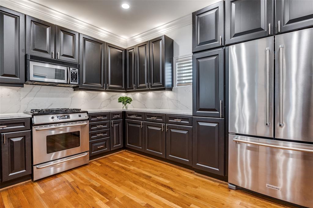 4223 Buena Vista Street, Unit 1 Dallas, TX 75205 - Photo 9 of 22 a kitchen with stainless steel appliances granite countertop a refrigerator stove and microwave