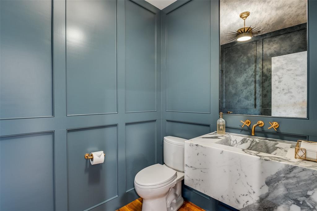 4223 Buena Vista Street, Unit 1 Dallas, TX 75205 - Photo 10 of 22 a bathroom with a granite countertop toilet and a sink